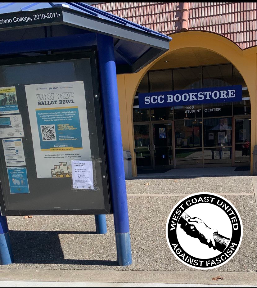 In front of a campus bookstore is a bulletin board. Adheared to the front is a white flyer that read "Every campus, every town. Where they go, we shut them down." with the logo for Turning Point USA.